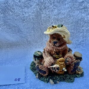 Beekeeper with jars of honey and flowers